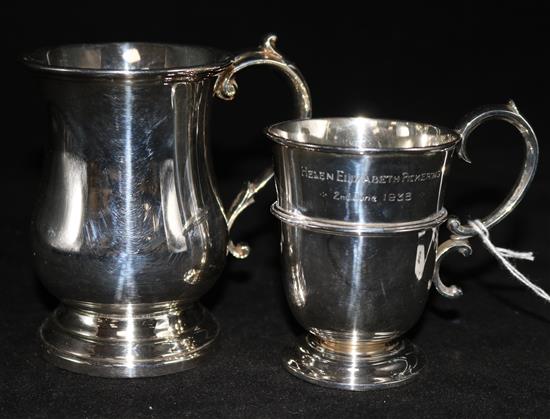 A late Victorian silver christening cup and a later silver mug.